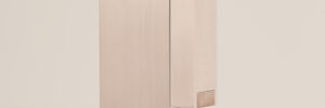 KNNOX premium brass lighter standing vertically on a beige background